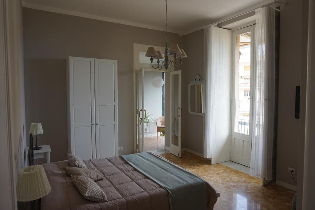 a bedroom with a bed and a large window at Suites in Sicily in Acireale