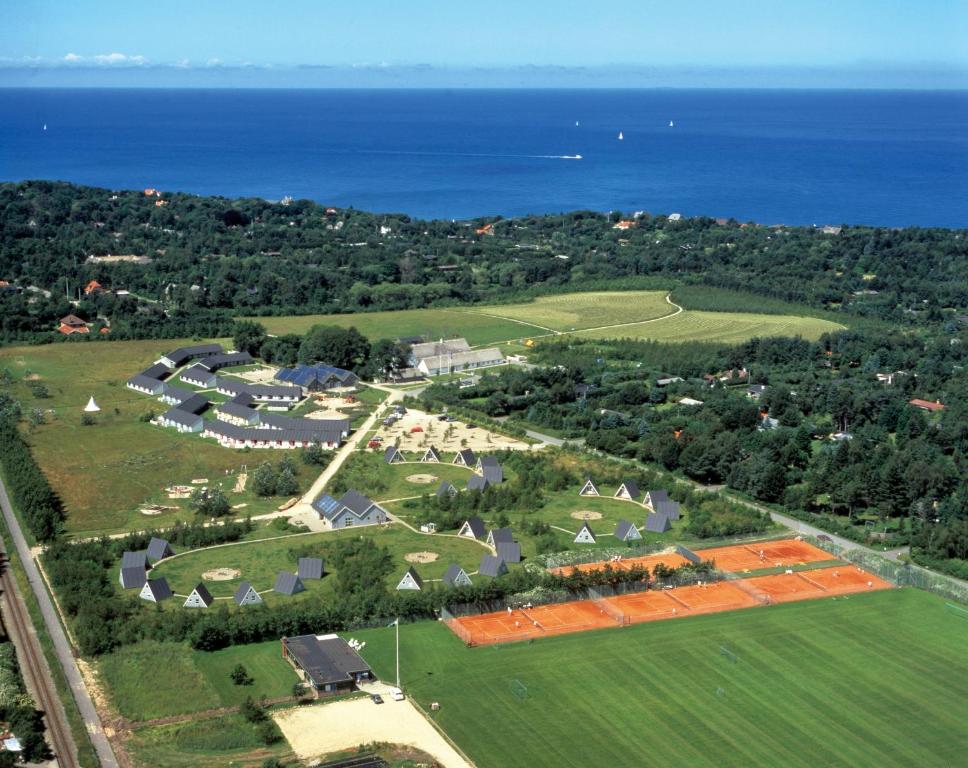 an aerial view of a house and the ocean at Sankt Helene Holiday Center in Tisvildeleje