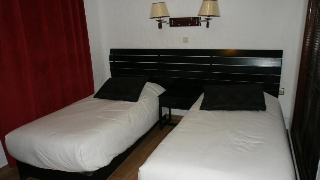 Postel nebo postele na pokoji v ubytování Hotel Hacienda