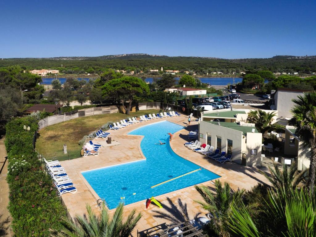 an aerial view of a resort pool with lounge chairs at Belambra Clubs Résidence Gruissan - Les Ayguades in Gruissan