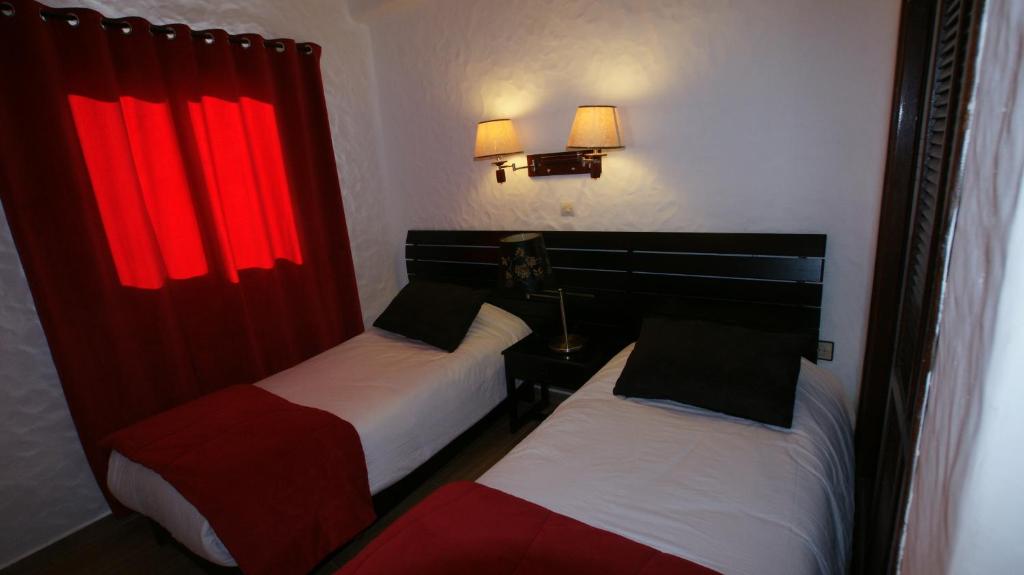 Postel nebo postele na pokoji v ubytování Hotel Hacienda