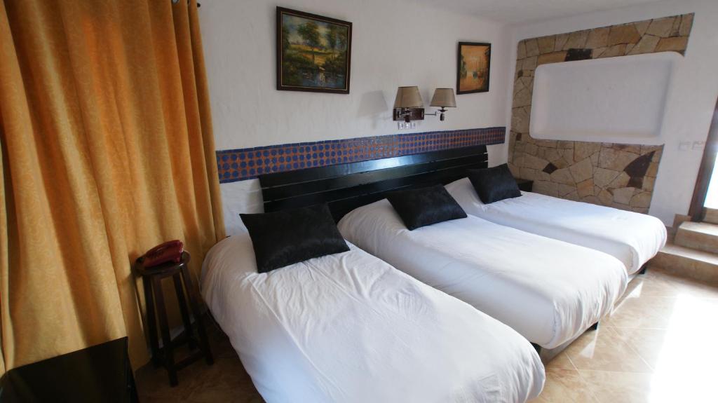 Postel nebo postele na pokoji v ubytování Hotel Hacienda