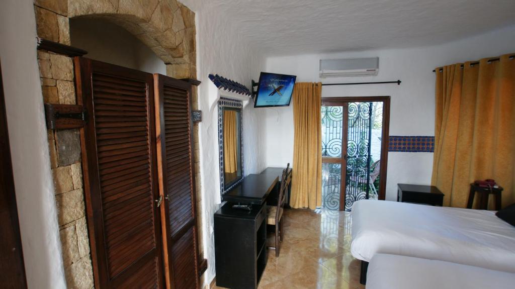 TV a/nebo společenská místnost v ubytování Hotel Hacienda