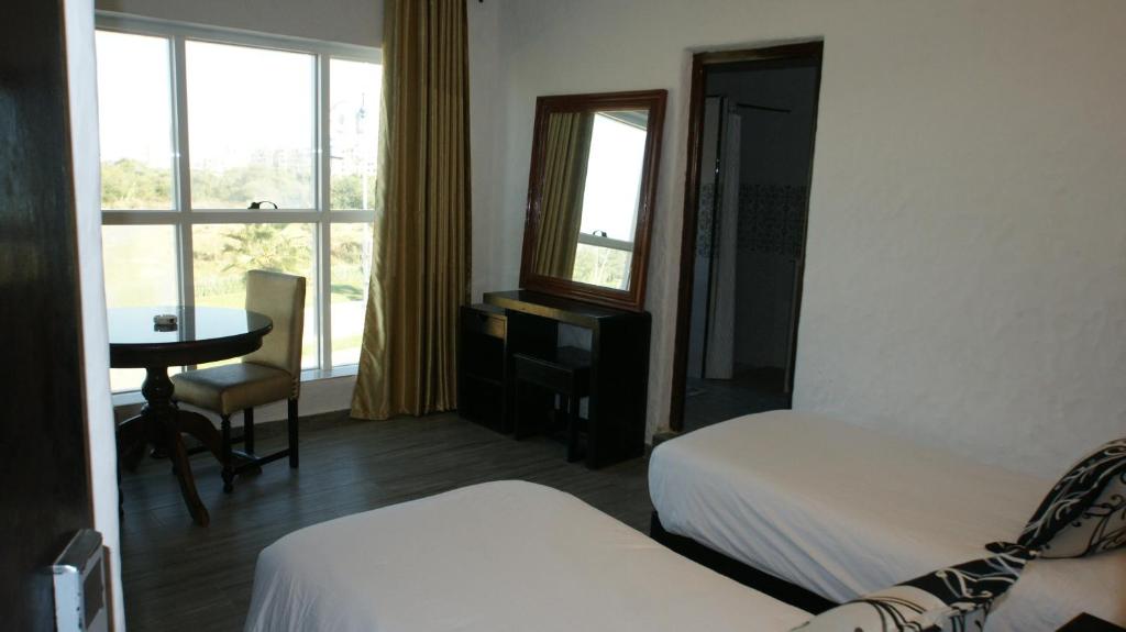 Postel nebo postele na pokoji v ubytování Hotel Hacienda