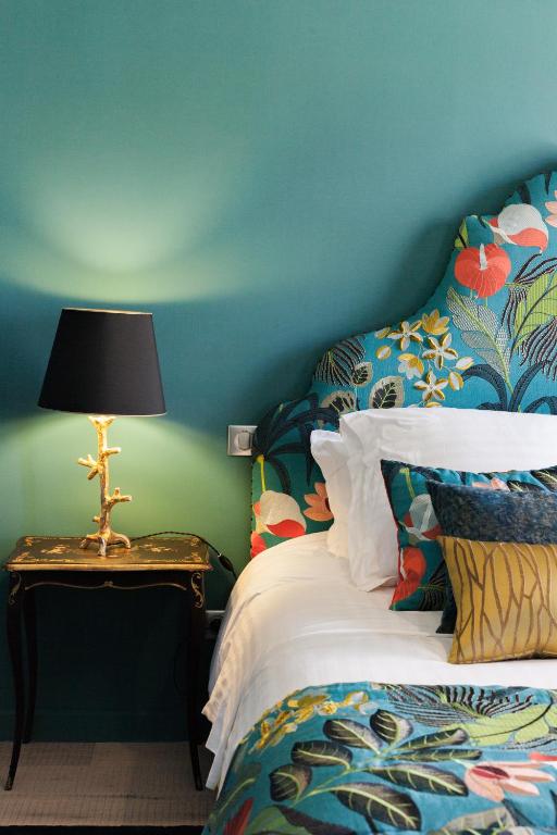 une chambre avec un lit et une table avec une lampe dans l'établissement Maison Du Collectionneur, à Aix-en-Provence