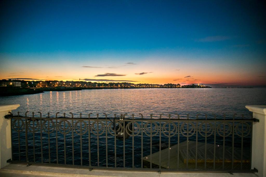 a view of a large body of water at sunset at Villa Ascosa - Relais sul Mare in Trani