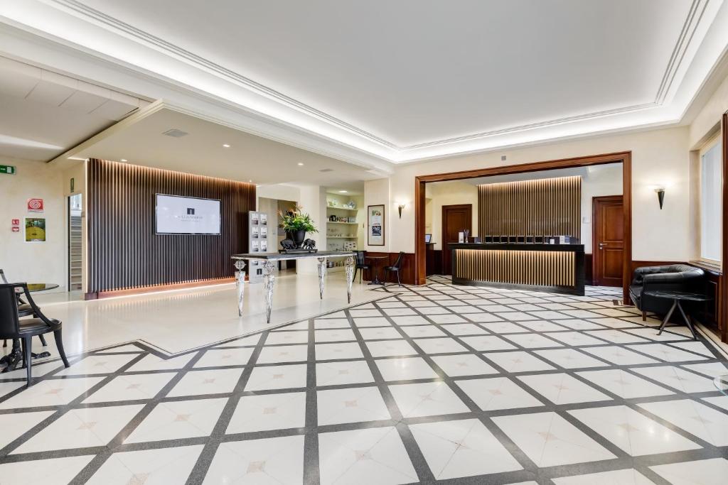 a large lobby with a table and a piano at Villa Maria Hotel & SPA in Francavilla al Mare