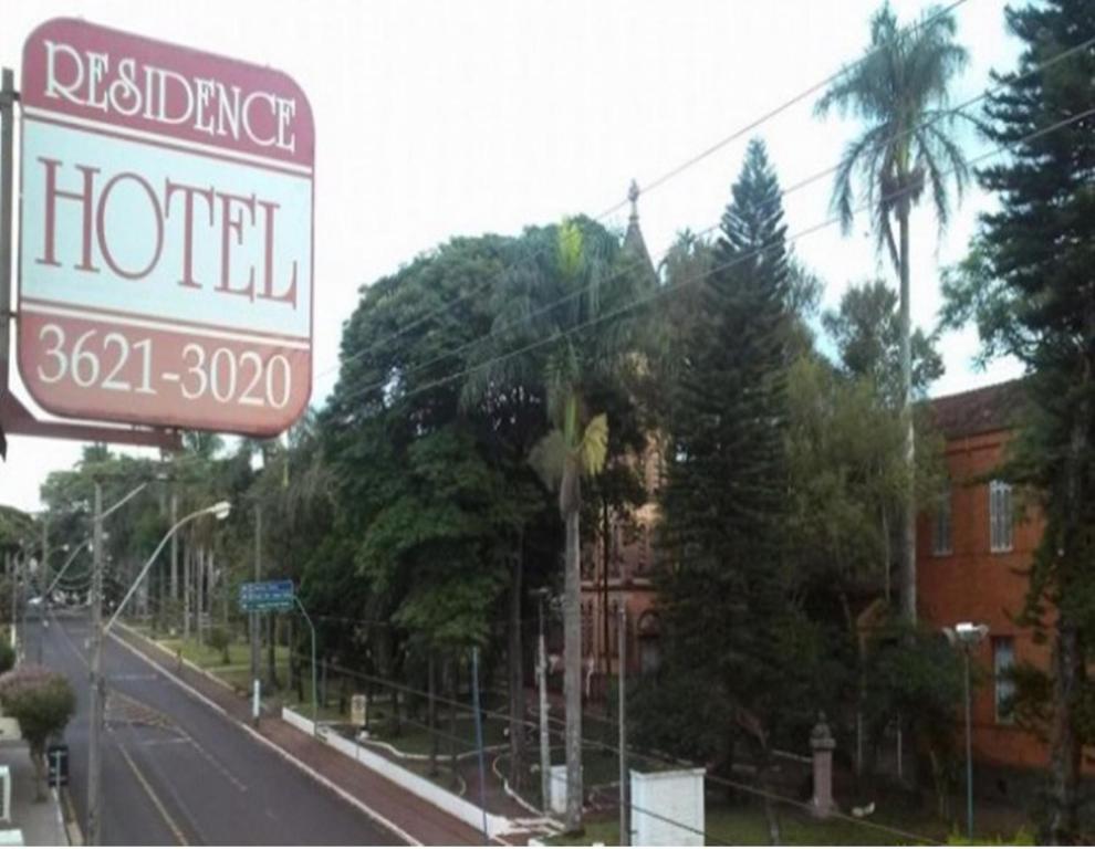 a hotel sign on the side of a street at Residence Hotel in Jaú