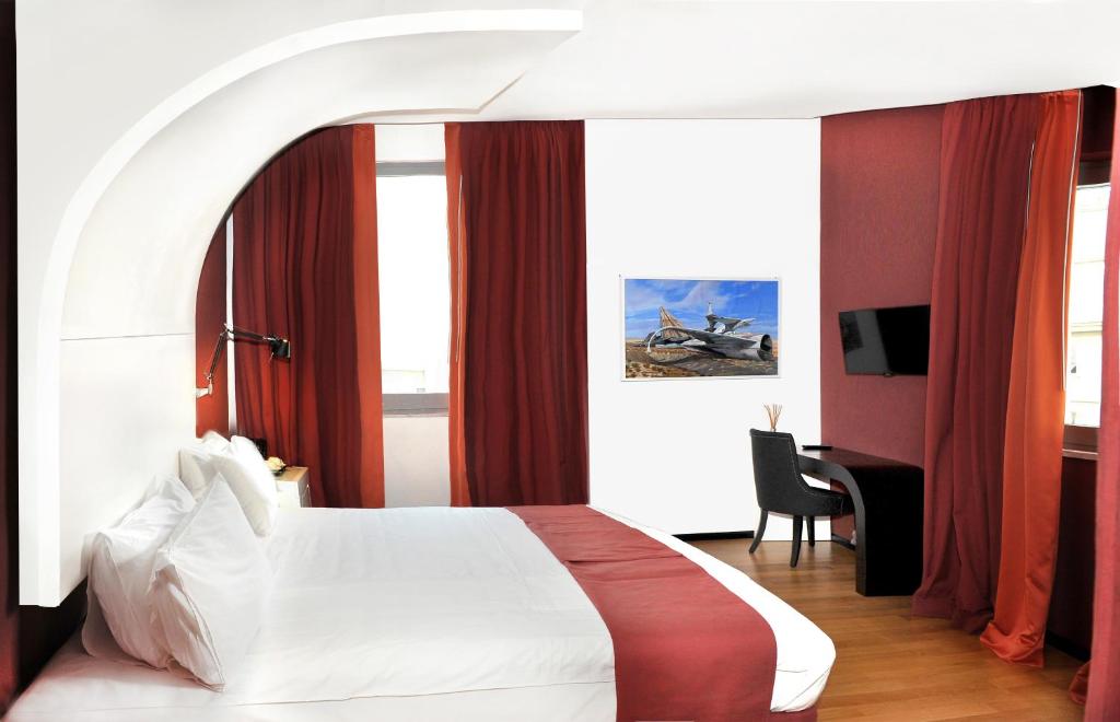 a hotel room with a bed and a television at Culture Hotel Centro Storico in Naples