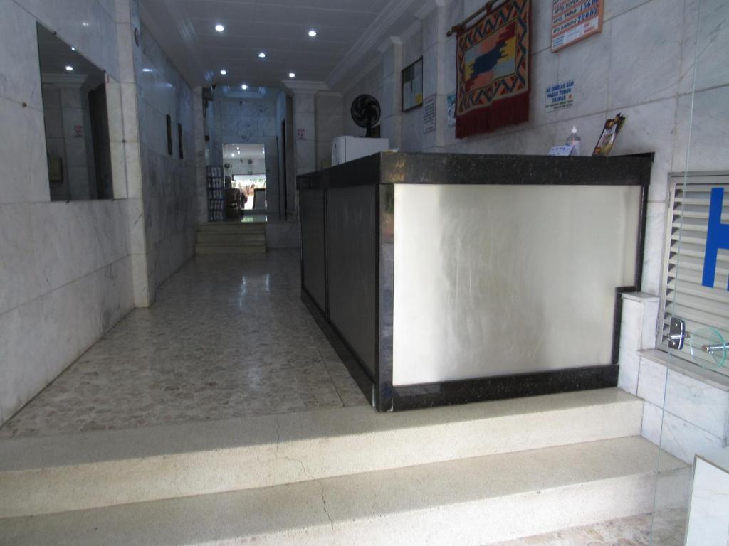 a lobby with a counter and stairs in a building at Hotel Moraes a 10 minutos da 25 de Março,Brás,Bom Retiro,a 2 minutos do Mirante Sampa Sky e pista de Skate Anhangabaú in Sao Paulo