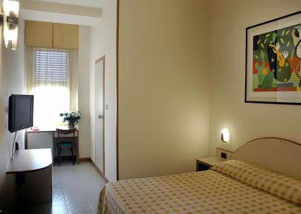 Postel nebo postele na pokoji v ubytování Hotel Napoleon