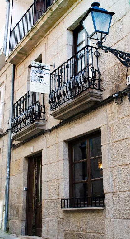 a building with balconies and a street light on it at A Lareira De Allariz in Allariz