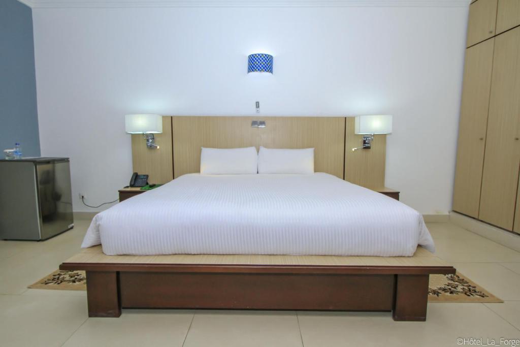 Postel nebo postele na pokoji v ubytování Hotel LAFORGE