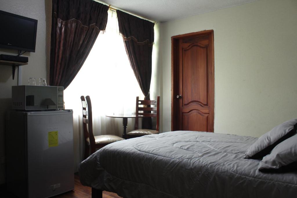 Postel nebo postele na pokoji v ubytování Altura Rooms & Suites