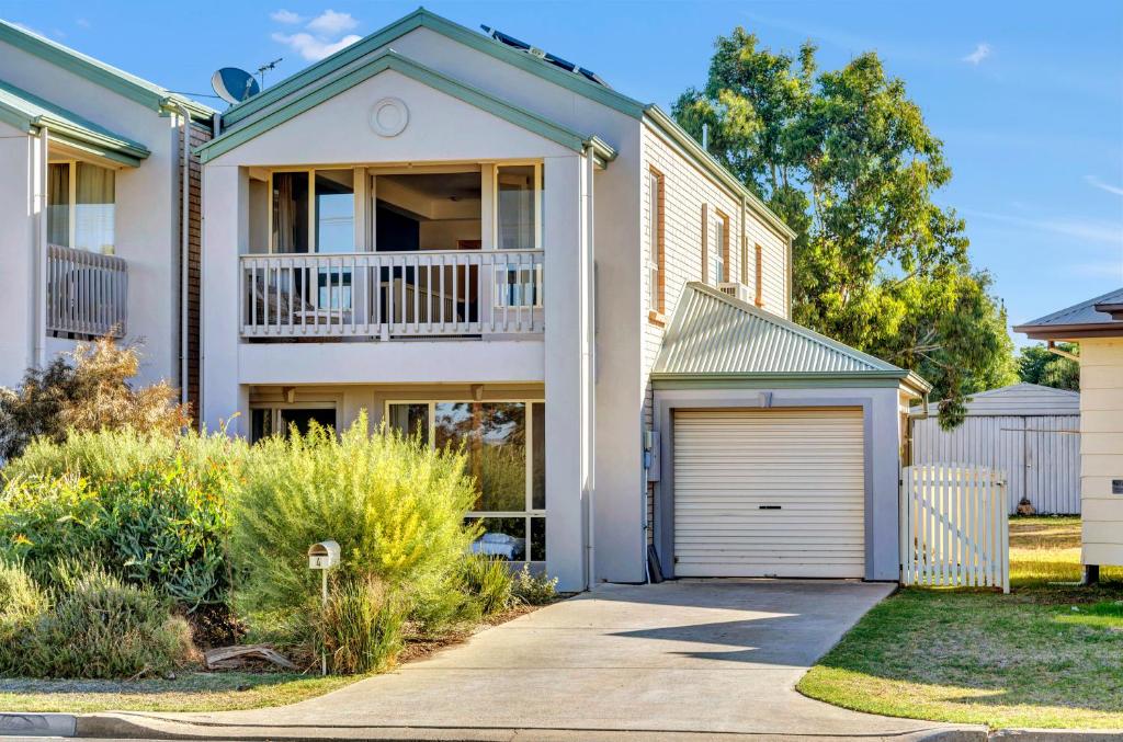 a house with a balcony and a garage at The Lighthouse - Port Willunga - C21 SouthCoast Holidays in Port Willunga