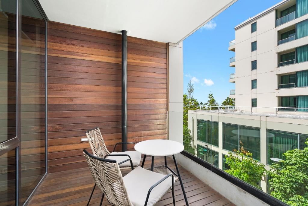 a balcony with a table and chairs on a building at Edgewater 207 in Geelong