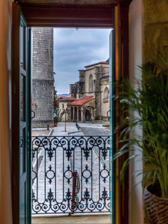 a window view of a church from a balcony at Apartamento Carlos V in Hondarribia