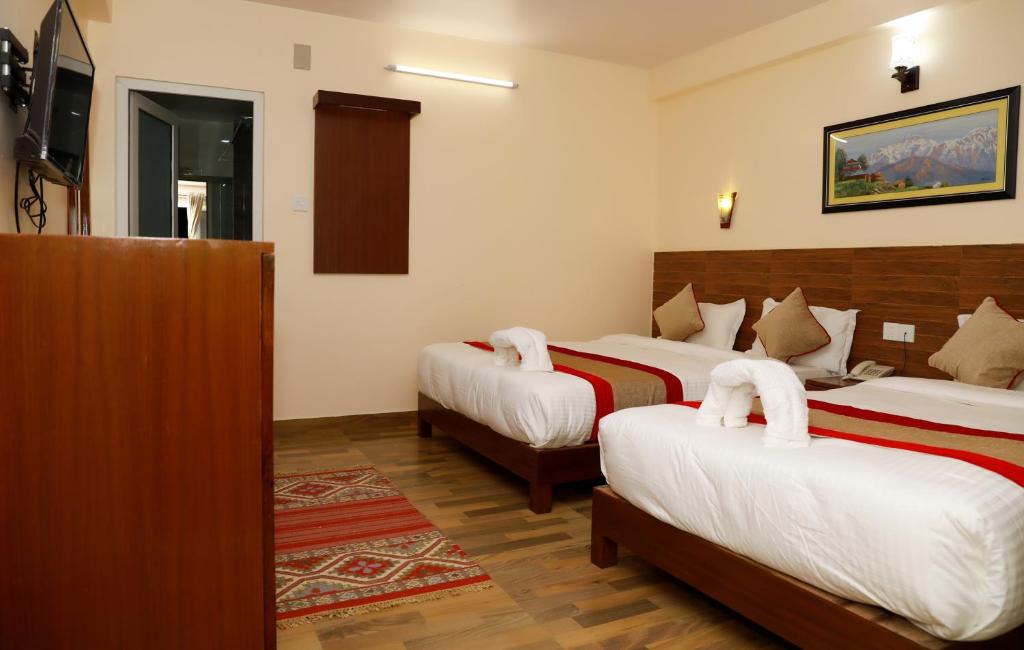 Letto o letti in una camera di Hotel Guru