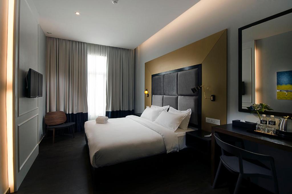 Postel nebo postele na pokoji v ubytování Palm Hotel Ipoh