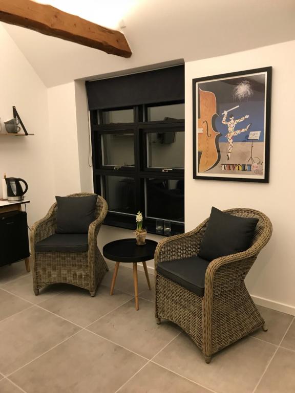 a living room with two chairs and a table at Gl.Hastrup Guesthouse in Køge