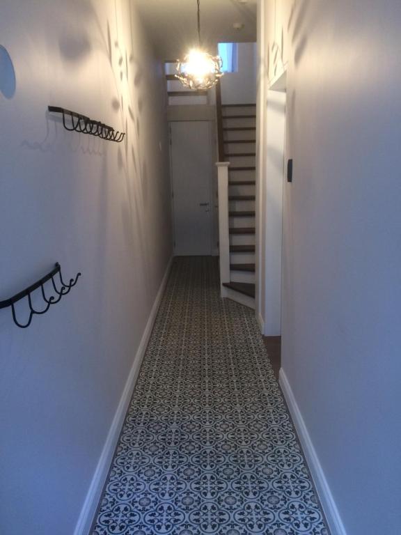 a hallway with a tile floor and a staircase at ChilloutOostende in Ostend