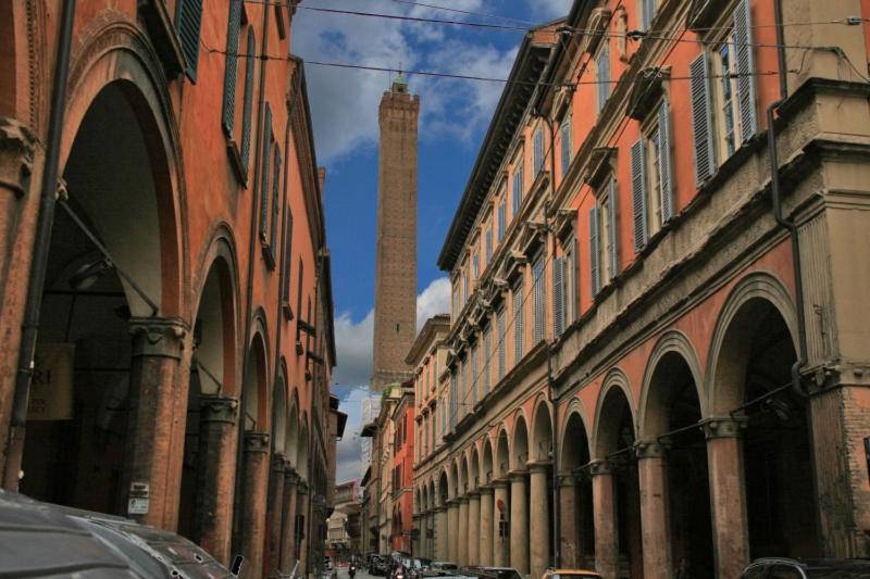 a row of buildings with a tall tower in the distance at B&B Mercedes in Bologna