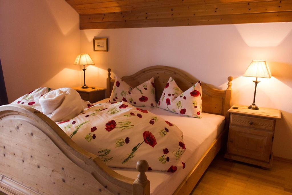 a bedroom with a bed with a floral bedspread and pillows at Schwaningerhof in Cermes