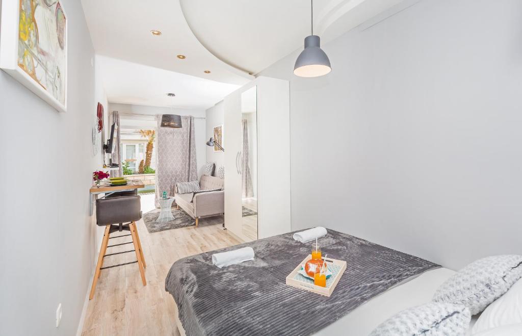 a bedroom with a bed with a tray on it at Apartments Summer Romance in Dubrovnik
