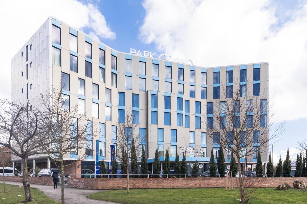 a large white building with a sign on it at Park Grand Heathrow in Hounslow