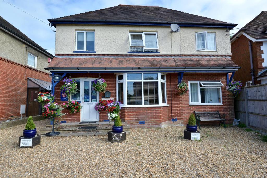 a house with potted plants in front of it at Rosedale Bed and Breakfast in Lyndhurst