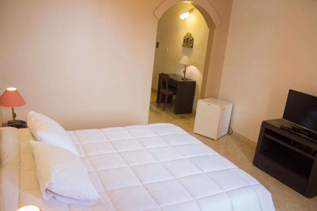 Łóżko lub łóżka w pokoju w obiekcie Asuncion Palace