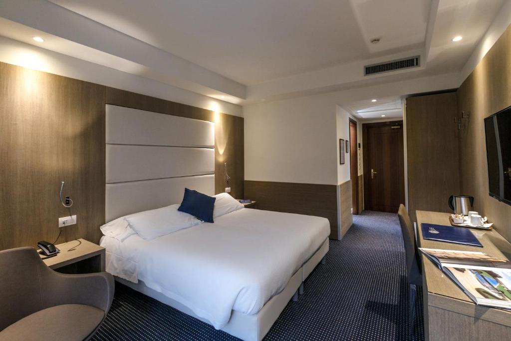 Postel nebo postele na pokoji v ubytování Hotel Terme Millepini