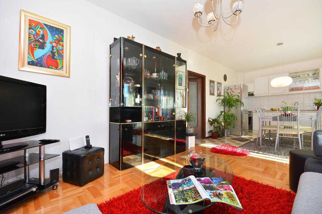 a living room with a large black cabinet at Artsy Apartment in Klis