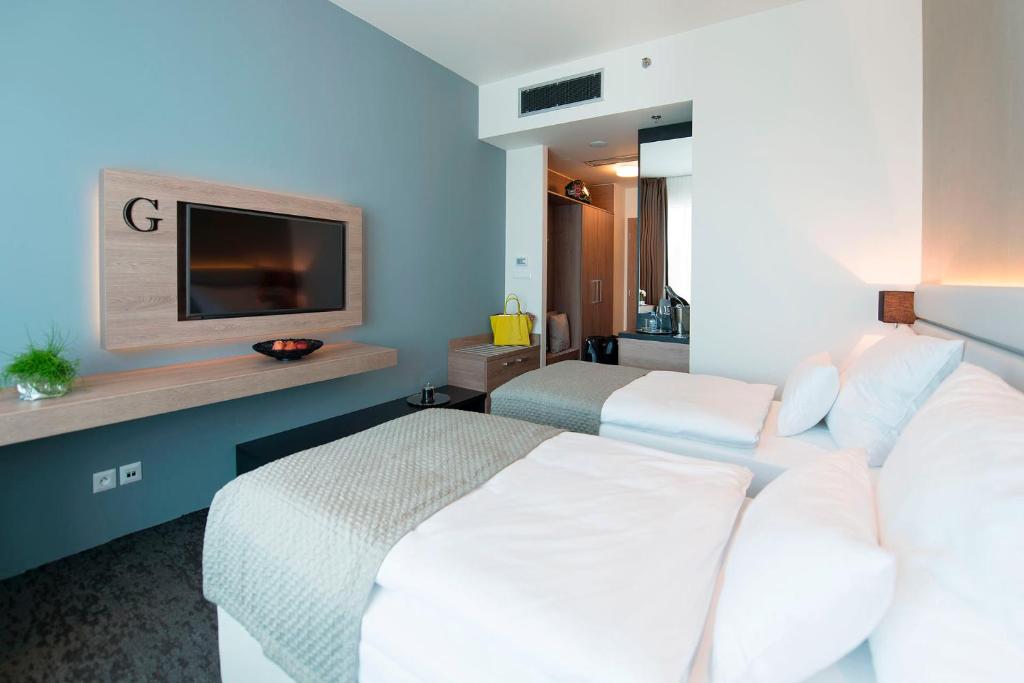 Postel nebo postele na pokoji v ubytování Grid Hotel