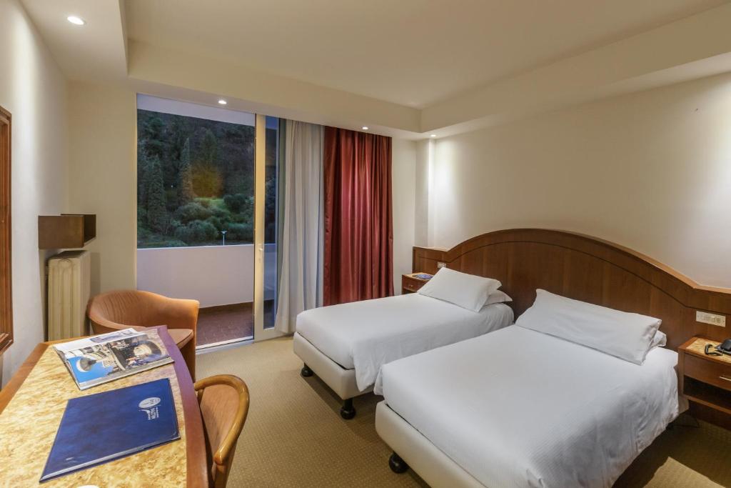 Postel nebo postele na pokoji v ubytování Hotel Terme Millepini
