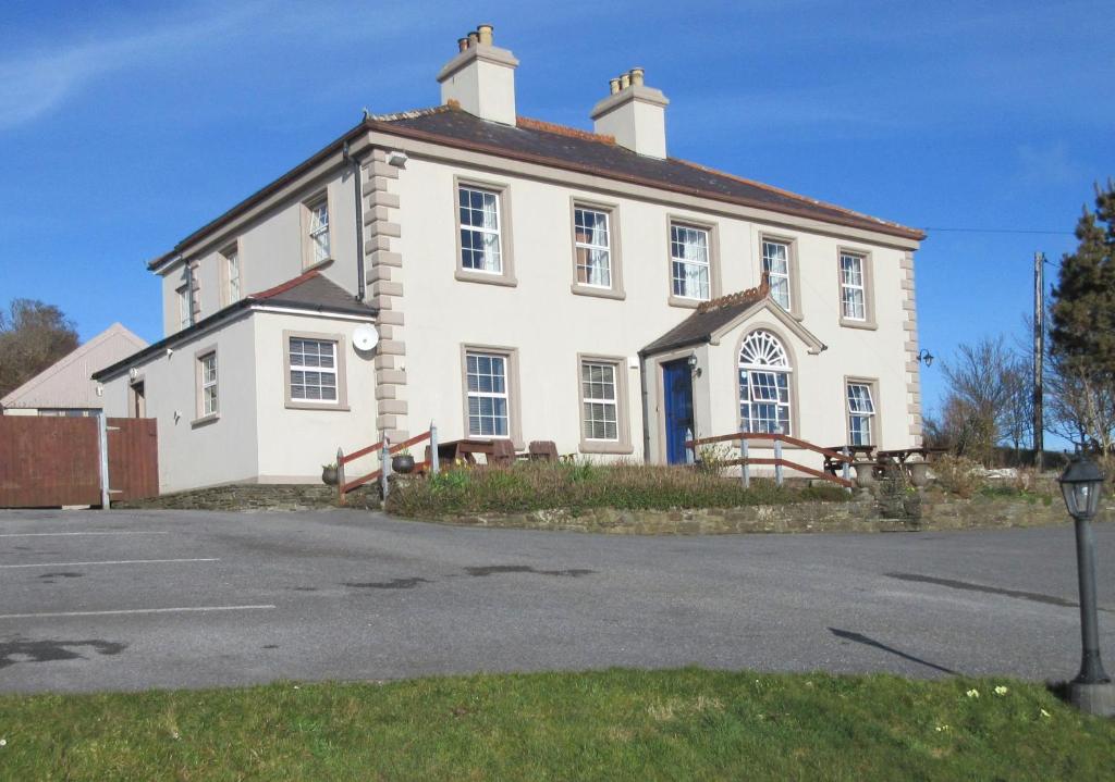 a large white house with a roof at Rathmore House Bed & Breakfast in Baltimore