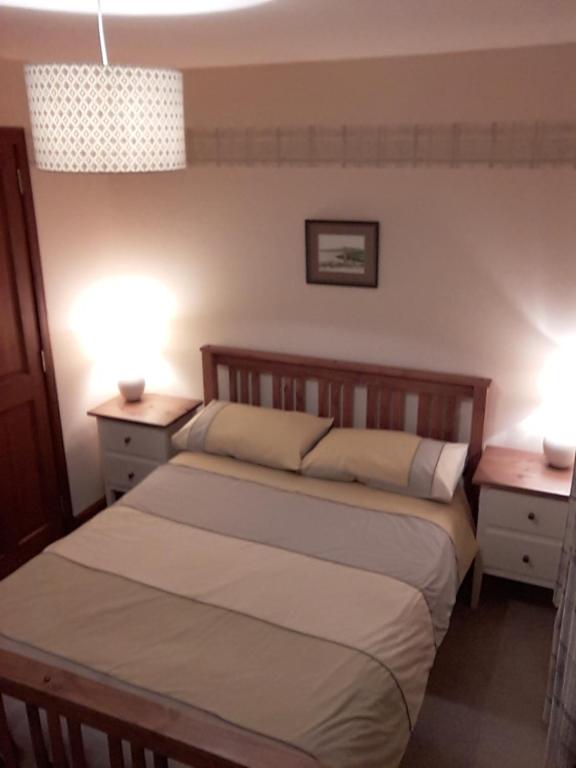 a bedroom with two beds and two night stands at The Pally - behind 13 Palace Road, Kirkwall, Orkney - STL OR00122F in Kirkwall