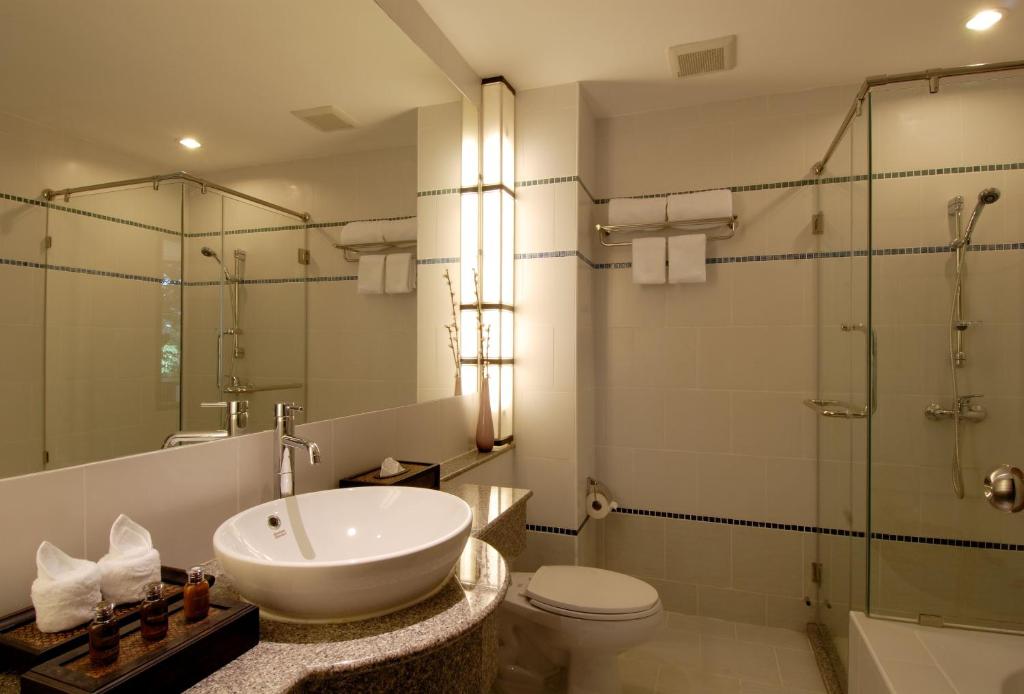 a bathroom with a sink and a toilet and a shower at Supalai Scenic Bay Resort And Spa, SHA Extra Plus in Por Bay