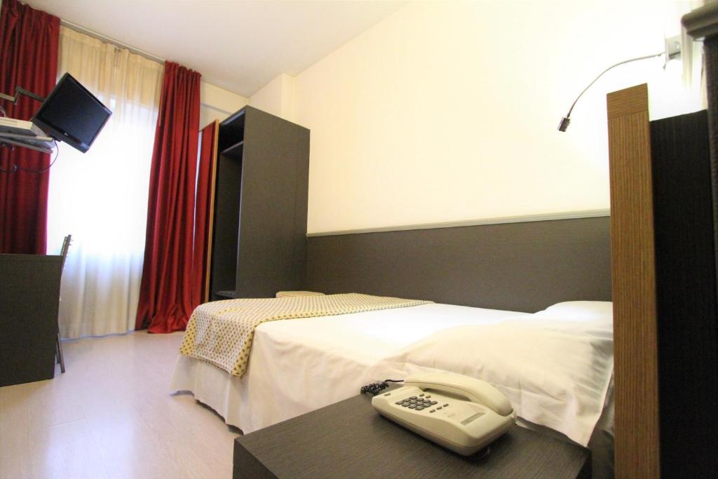 Postel nebo postele na pokoji v ubytování Hotel Corallo