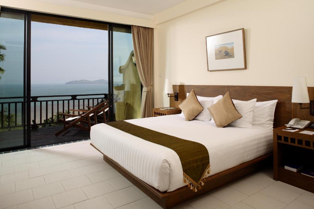 a hotel room with a bed and a balcony at Supalai Scenic Bay Resort And Spa, SHA Extra Plus in Por Bay