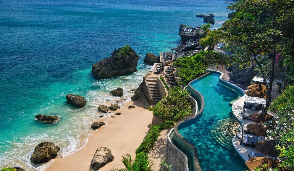 
a scenic view of a beach with palm trees at AYANA Resort and Spa, BALI in Jimbaran
