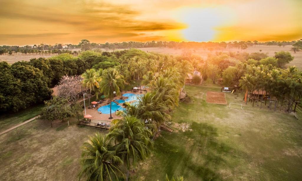 an aerial view of a resort with a pool and palm trees at Eco Resort Foz do Marinheiro in São João do Marinheiro