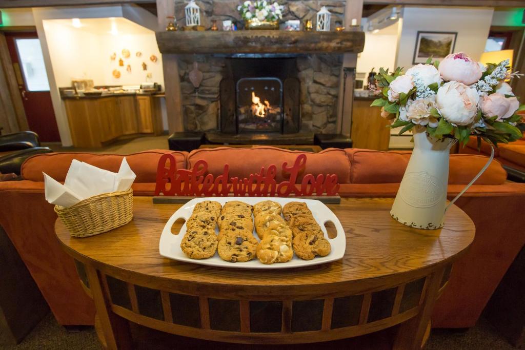 a tray of cookies on a table with a fireplace at Cristiana Guesthaus in Crested Butte