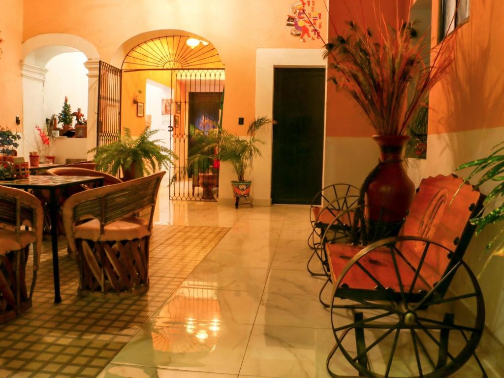 a room with a table and chairs and a vase with plants at Casa Santuario Hotel Boutique in Guadalajara