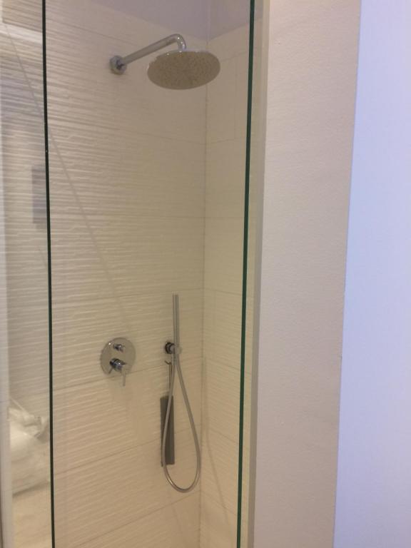 a shower with a glass door with a shower head at ChilloutOostende in Ostend