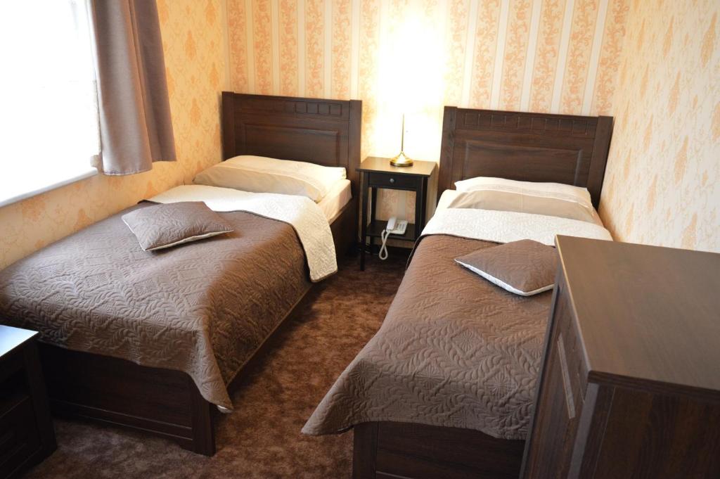 Postel nebo postele na pokoji v ubytování Hotel Lipa
