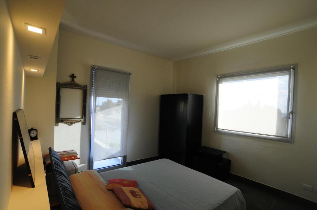Letto o letti in una camera di Art House Quartu - Margine Rosso
