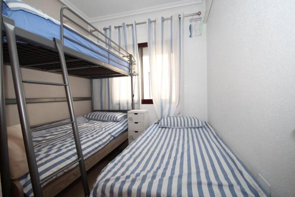 Postel nebo postele na pokoji v ubytování Orihuela Costa Costamarina Cabo Roig Apartamentos TIKASA