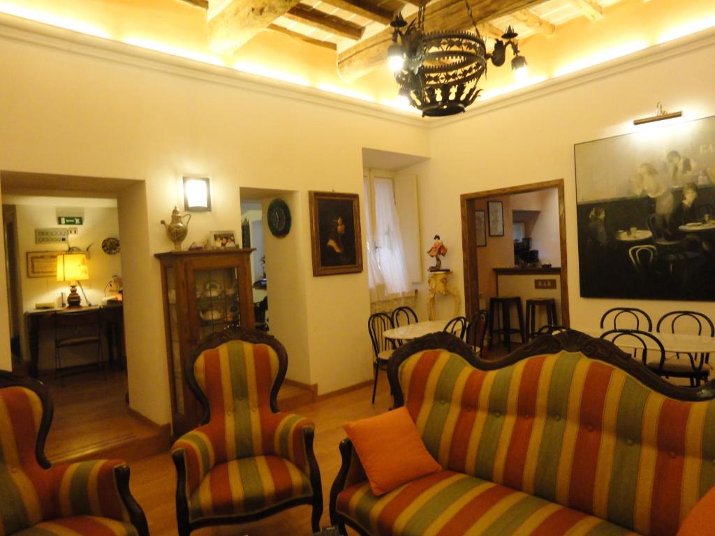a living room with two couches and a table at Hotel Morlacchi in Perugia