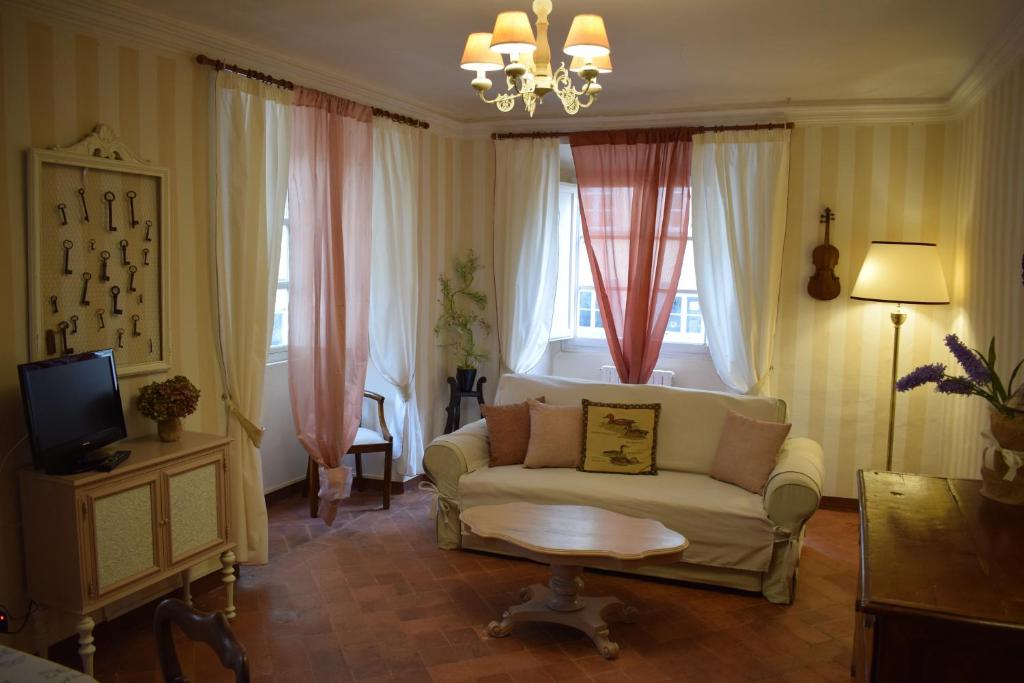 a living room with a couch and a tv at Palazzo Tucci Apartments in Lucca